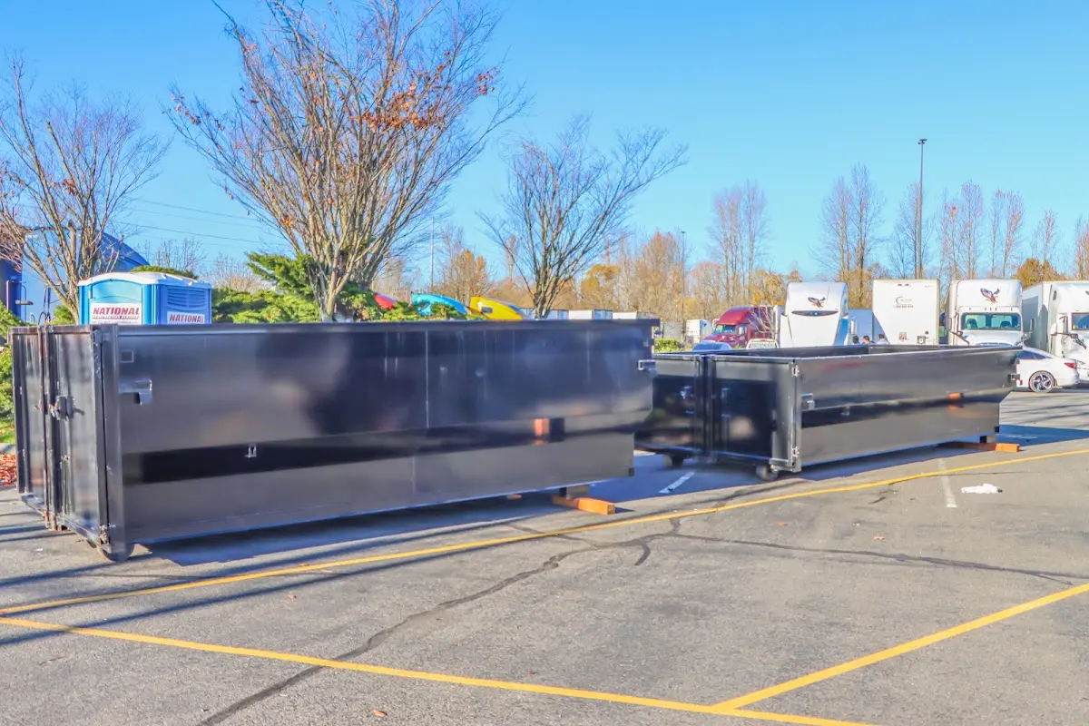 Professional dumpster rental service with roll-off container on residential driveway in Alpharetta